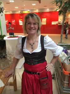 a woman standing in a store wearing a red dress at Gästehaus Lisa in Deutschlandsberg