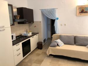 a kitchen with a couch in a small room at Apartments Maria in Supetar