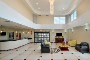 a lobby with couches and a waiting room at Ramada by Wyndham South Waco in Hewitt