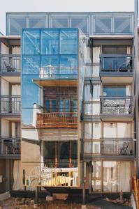 a glass facade of a building with a balcony at Bella 269 in Santiago