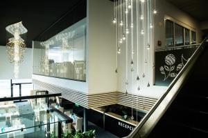 a staircase in a building with lights on the wall at Hotel Thermal ŠÍRAVA in Kaluža