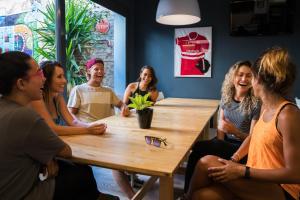 a group of people sitting around a table at Sant Jordi Hostels Gracia in Barcelona