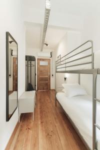 a bedroom with two bunk beds and a mirror at Puro Apartment in Porto