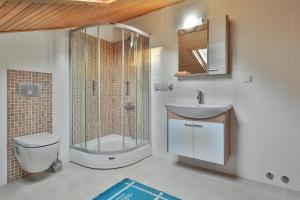 a bathroom with a shower and a toilet and a sink at Kasinn Apart Turuncu in Kaş +31 photos