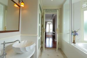 a bathroom with a large sink and a mirror at Hiranyakul House in Bangkok +51 photos