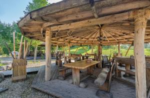 a wooden pavilion with a wooden table and benches at Žemsodis in Plungė +33 photos