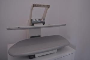 a shelf with a light on top of a machine at Ithaca in Perdika