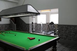 a pool table in the middle of a room at Victoria House in Barrow in Furness