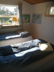 a bedroom with two beds and a window at Woody B&B in Jelling