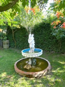 a fountain with a statue in a yard at Adega Do Martinho in Milhão