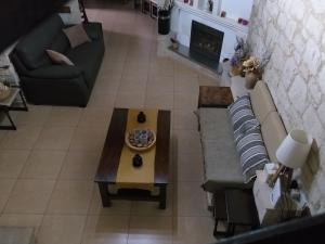 an overhead view of a living room with a couch and a table at Magdalous House in Arsos