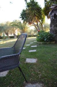 a bench sitting on the grass in a park at Sunny Garden in Plataria