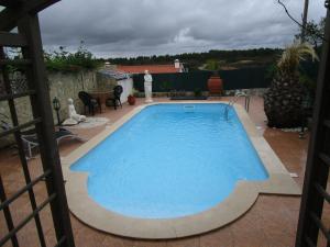 a large blue swimming pool on a patio at Casa Helena in Aljezur
