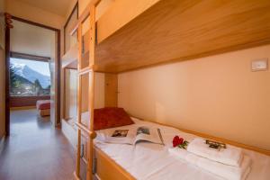 a bedroom with a bunk bed with a book at Résidence La Verte 15 ski in ski out - Happy Rentals in Chamonix