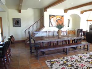 a dining room with a wooden table and chairs at Croad Vineyards - The Inn in Paso Robles