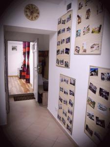 a hallway with pictures on the wall and a clock at Apartment Shesti Uchastak in Gabrovo