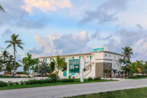 a large white building with a clock on the side of it at Fisher Inn Resort & Marina in Islamorada