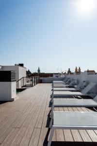 a row of benches on the roof of a building at Apartamentos Lanza in Seville