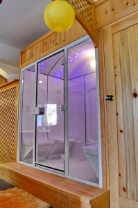 a bathroom with a glass shower in a room at Porto Antigo Hotel BB in Santa Maria