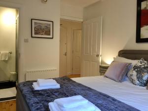 een slaapkamer met een bed met twee handdoeken erop bij City Centre Belfast Free Parking in Belfast