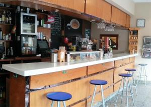 a bar in a restaurant with stools at Hotel Carbayon in Oviedo