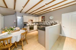 a kitchen with a table and chairs in a room at Seal Cottage in Hexham