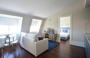 uma sala de estar com um sofá branco e uma cama em YOUROPO - Market no Porto