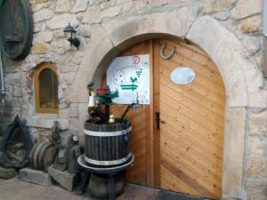 a wooden door in a building with a barrel at Ferienweingut- Schäfer in Göcklingen