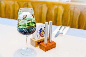 a wine glass with fish in it sitting on a table at Taverna Unik in Saaldorf