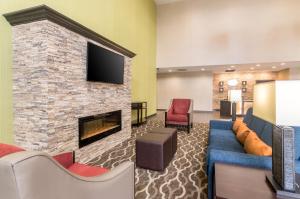 a lobby with a couch and a fireplace at Comfort Suites Meridian and I-40 in Oklahoma City