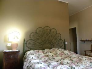 a bedroom with a bed and a lamp on a table at La Ginestra in Todi