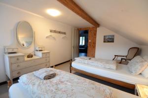 a bedroom with two beds and a dresser and a mirror at Mountain Views in Interlaken