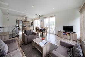 a living room with a couch and a table at Apartment Słoneczny Gródek 38 in Gródek Nad Dunajcem