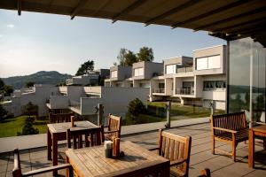 a patio with tables and chairs and a building at Apartment Słoneczny Gródek 38 in Gródek Nad Dunajcem