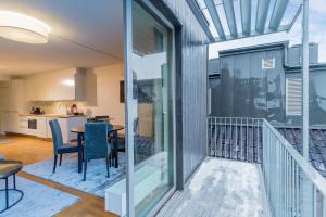 a room with a balcony with a table and chairs at Nordic Host - Prinsens Gate 10 city center - High-end in Oslo