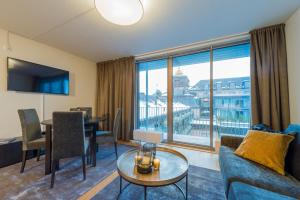 a living room with a couch and a table at Nordic Host - Prinsens Gate 10 city center - High-end in Oslo