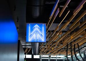 a blue sign hanging from the ceiling of a building at The Source Hotel in Denver