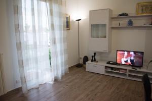 a living room with a flat screen tv sitting on a cabinet at guest house for you in Modena