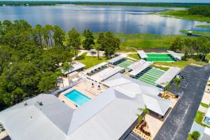 an aerial view of a house with a pool and a lake at Buttonwood Bay in Sebring