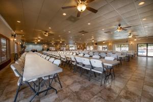 a large room with rows of tables and chairs at Buttonwood Bay in Sebring
