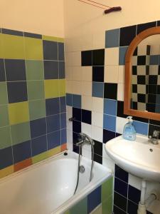 
a bathroom with a sink, mirror, and bathtub at Hotel Galeria in Bratislava

