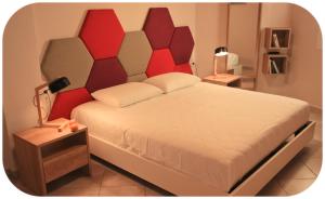 a bedroom with a large bed with a red headboard at Altanahouse in Parga