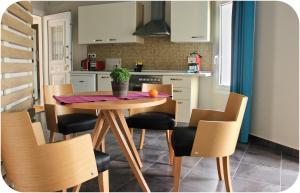 a kitchen with a wooden table and chairs at Altanahouse in Parga