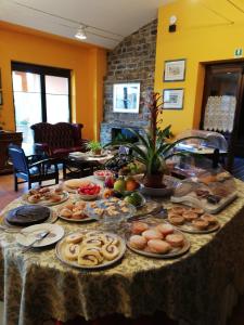 a table with many plates of food on it at La Foresteria di San Leo in Trivigno