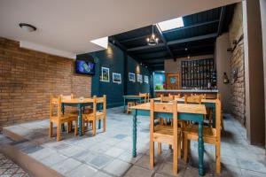 a dining room with wooden tables and chairs at San Rocke House in Cuenca