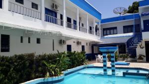 a swimming pool in front of a building at Regine's Hotel in Itaquatiara