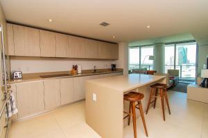 a kitchen with a counter and some stools at HYDE Beach 4111 S Ocean Dr in Hollywood