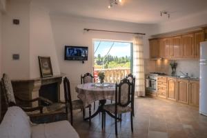 a kitchen with a table and a kitchen with a window at Modern flat with beautiful views in south of Corfu in Lefkímmi