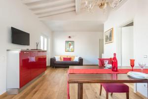 a living room with a table and a couch at Lovewknds - Topfloor with Duomo View in Florence