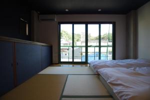 Postel nebo postele na pokoji v ubytování Cinnamon Guesthouse Dogo